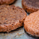 vegan burgers cooking on grill